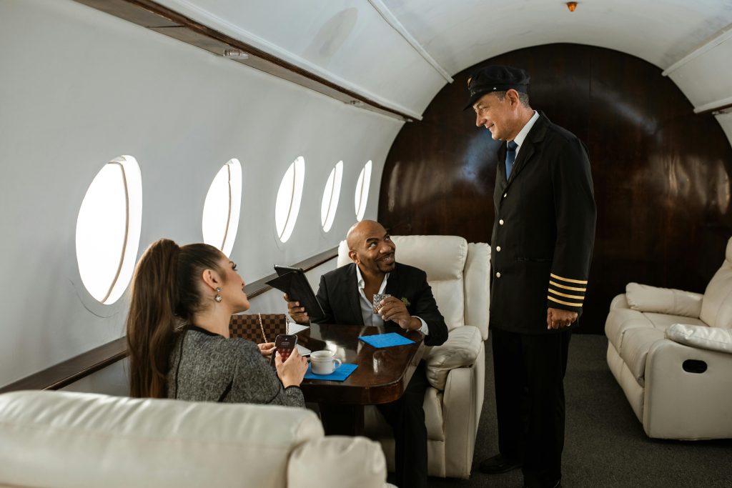 Professionals engaging in conversation with the pilot on a private jet.